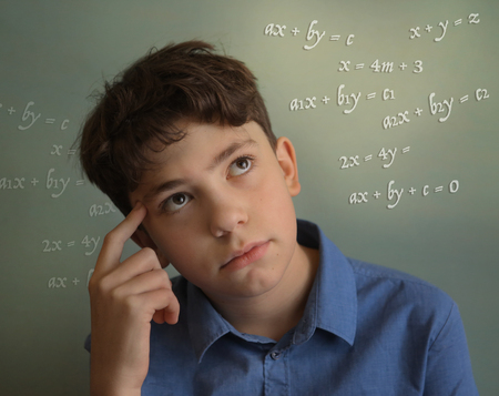 teenager student boy calculating thinking on math equation close up photoの写真素材