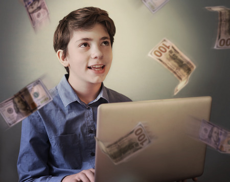 talented successful ambitious teenager boy with laptop freelance working earn money on internetの写真素材