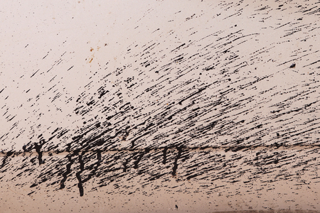 bitumen ashpalt spray spot on the car door close up texture photoの写真素材