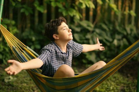 teenager boy resting in hammockの写真素材