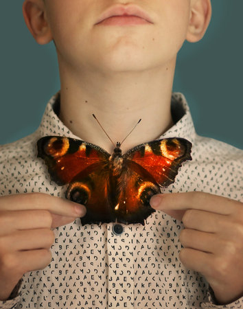 teenager boy with shirt (print contain half erased english alphabeth lettersin random order)...