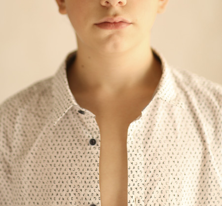teenager boy in cotton white unbuttoned shirt close up cut photoの写真素材