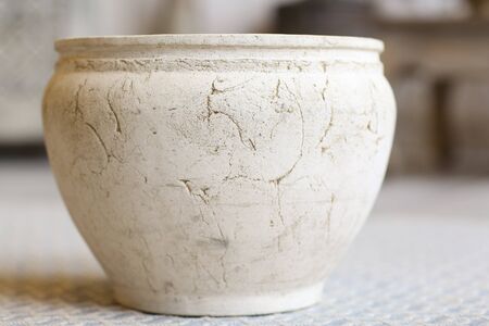 clay white pot in oriental style in deep crack and scratchesの写真素材