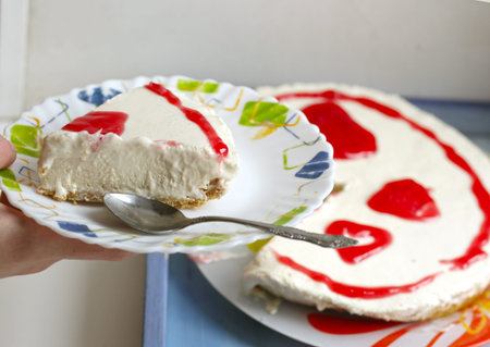 cheese cake with strawberry jam topping close up photo with tea set