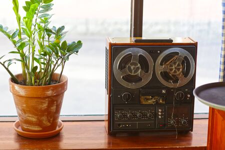 old retro reel-to-reel tape recorder close up photo on cafe backgroundの写真素材