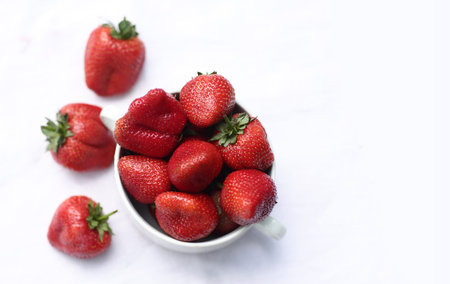 healthy breakfast - strawberries in bowl close up photo with copy space isolated on white