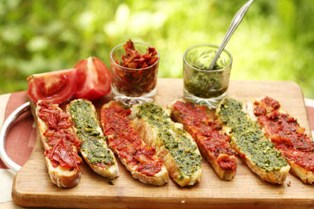 hot chili tomato and pesto sauce, sliced roasted italian ciabatta bread for cooking bruschetta sandwichesの写真素材