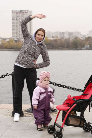 Moscow, Russia, October 30, 2020: Unidentified women with kids on pram fitness lesson with instructor in Moscow.のeditorial素材