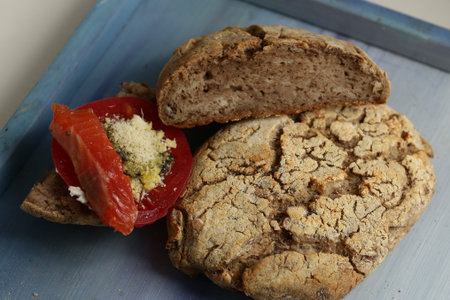 gluten-free ciabatta bread with bruschetta tomato salmon and parmesan cheese close up photo on...