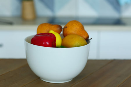 fruit in bowl still life on the table closeup photo on blue kitchen backgroundの写真素材