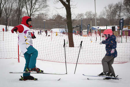 Alpine skiing master class for kids with instructor in winter sports school for children.のeditorial素材