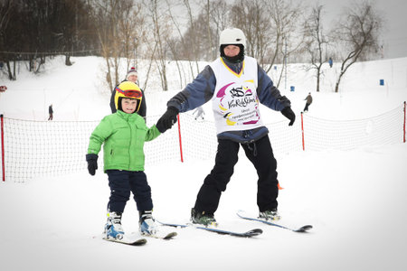 Alpine skiing master class for kids with instructor in winter sports school for children.のeditorial素材