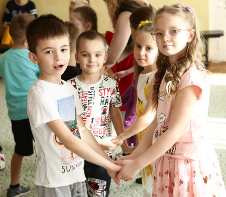 Unidentified kids dancing on graduation ball fest in kindergarten in Moscow, 2021.