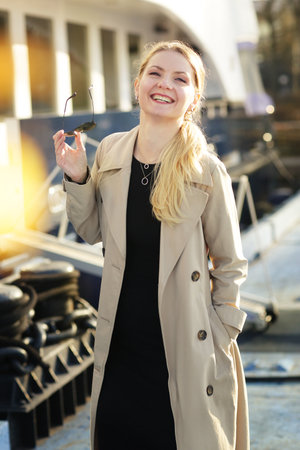 young blond slavic woman with long hair street portrait with glasses on marina boat backgroundの写真素材