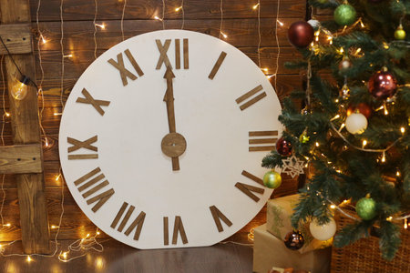 Christmas tree in xmas decorated room with clock, presents, garlands and Cristmas decoration