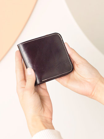 brown leather purse closeup photo in human hand