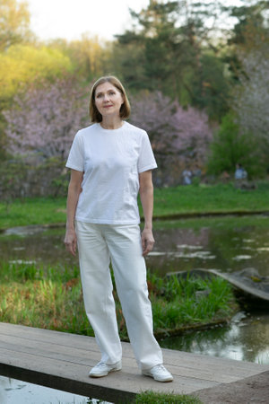 beautiful woman closeup photo in Japanese summer garden with sakura blossomの写真素材