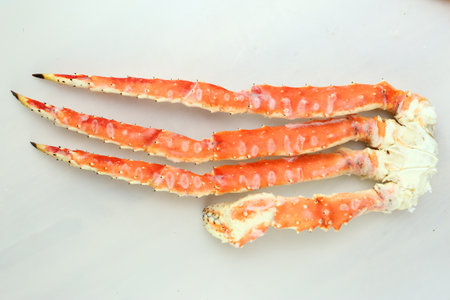 frosted Alaska king crab legs closeup photo on white table backgroundの写真素材
