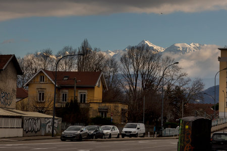 stunning winter view of Grenoble town with snow mountains on the background