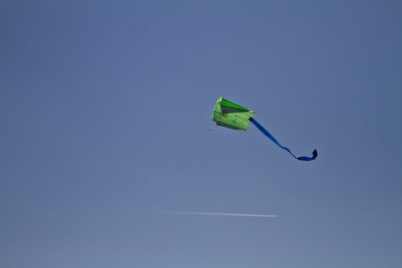 Flying a kite in the bright blue clear sky