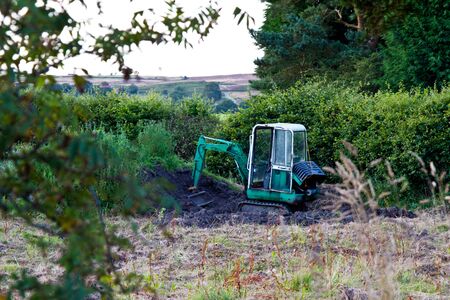 Digger in a farmers fieldの写真素材