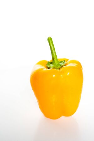 A whole yellow pepper against a plain whit backgroundの写真素材