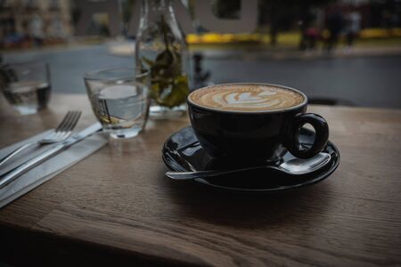 A close up of a cappuccino coffee at a cafe restaurantの写真素材