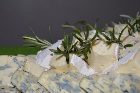 Zoom on some cheese decorated with rosemaryの写真素材