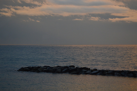 Sunset on the Mediterranean sea from the viewpoint of italy, with cloudy skyの写真素材