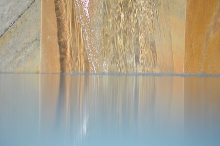 Zoom on a small waterfall from a Swimming poolの写真素材