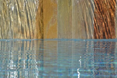 Zoom on a small waterfall from a Swimming poolの写真素材