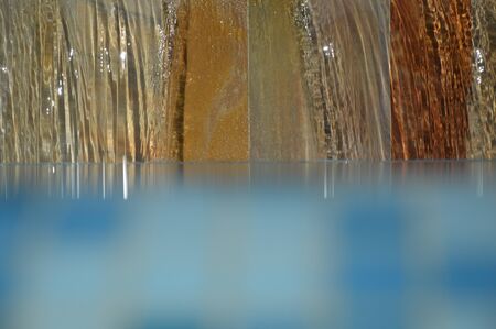 Zoom on a small waterfall from a Swimming poolの写真素材