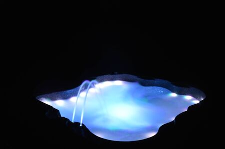 Closeup on a spa with interior lighting at nightの写真素材