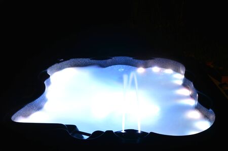 Closeup on a spa with interior lighting at nightの写真素材