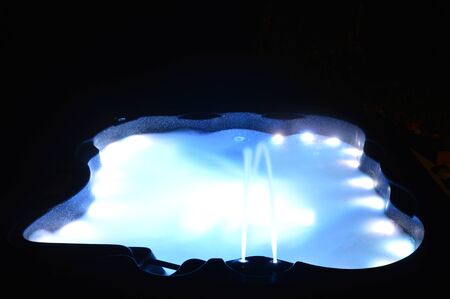 Closeup on a spa with interior lighting at nightの写真素材
