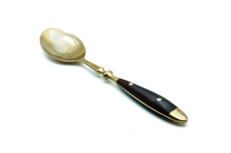 brass spoon isolated on a white backgroundの写真素材