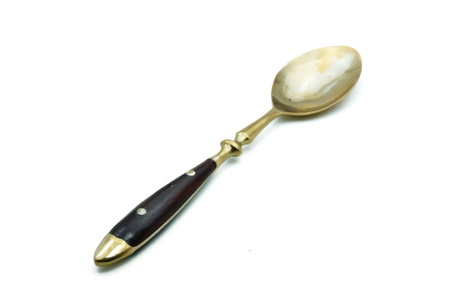 brass spoon isolated on a white backgroundの写真素材