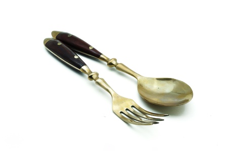 brass spoon and fork isolated on a white backgroundの写真素材