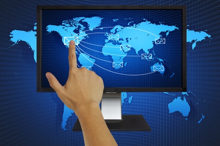 Hand pressing world wide mail on computer LCD Monitorの写真素材
