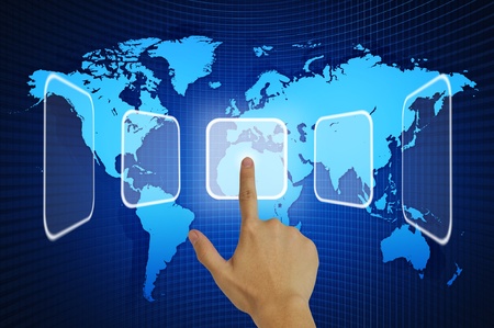 Hand pressing touchscreen button on the world map backgroundの写真素材