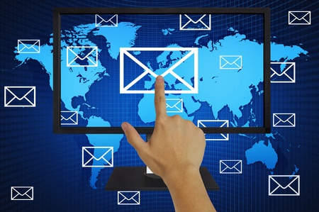 Hand pressing world wide mail on computer LCD Monitorの写真素材