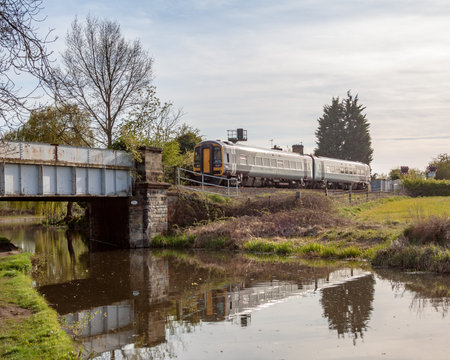 Willington. Derbyshire, UK, April,23,2021: A class 158 diesel Multiple unit train crosses the Trent and Mersey Canal near Willington Derbyshire on a East Midlands Railway Service from Derby to Crewe via Stoke on Trent.のeditorial素材