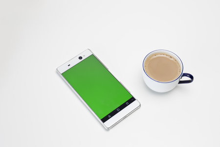 Cup of coffee and smartphone green screenの写真素材