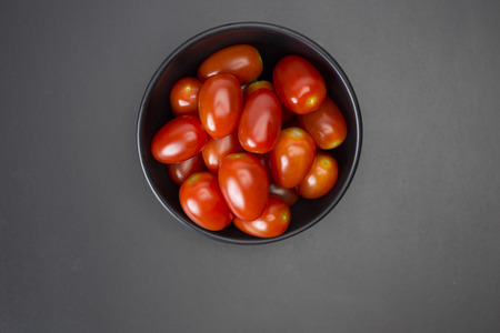 tomato in black bowlの写真素材