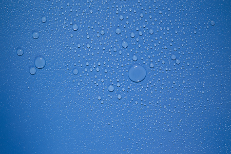 Water drop on blue backgroundの写真素材