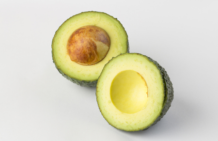 Avocado halves isolated on whiteの写真素材