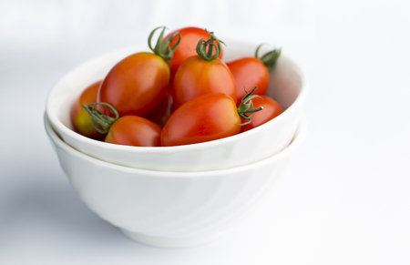 Cherry tomatoes in white bowlの写真素材