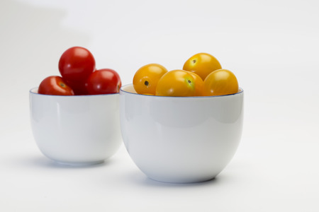 Cherry tomatoes in white cupの写真素材