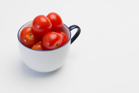 Cherry tomatoes in white cupの写真素材