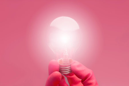 Hand holding light bulb